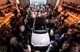Rivian Sales Rise as New EV Model Is Launched | Rivian reduces 2026 spending plans, narrows earni…